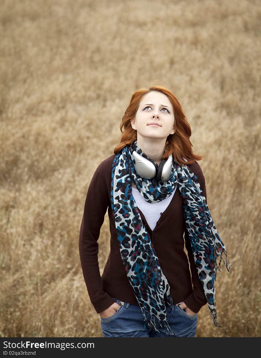 Young Girl With Headphones At Field.