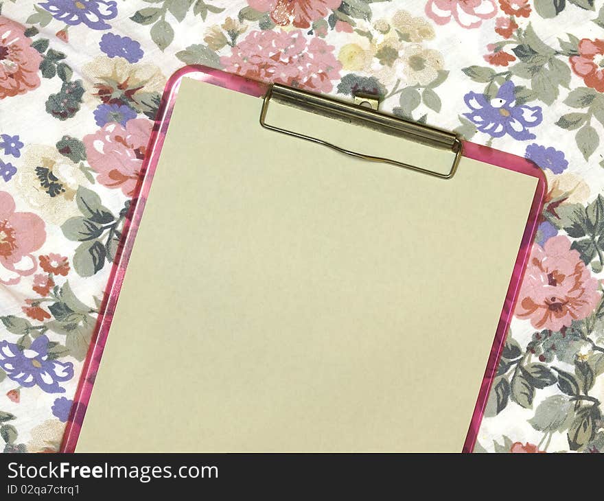 Blank page on pink feminine clipboard on floral background for school or business