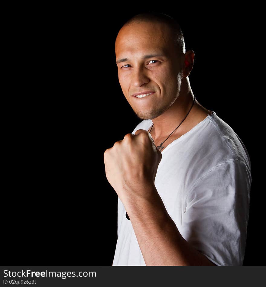 Young male filipino model over a black background is gesturing with his hand. Young male filipino model over a black background is gesturing with his hand.