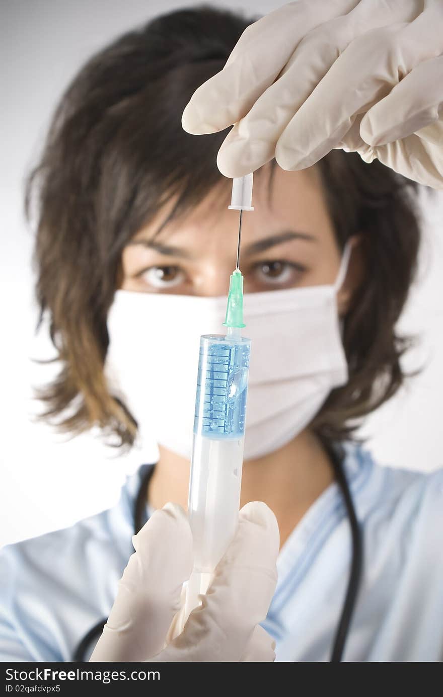 Young medical doctor with syringe