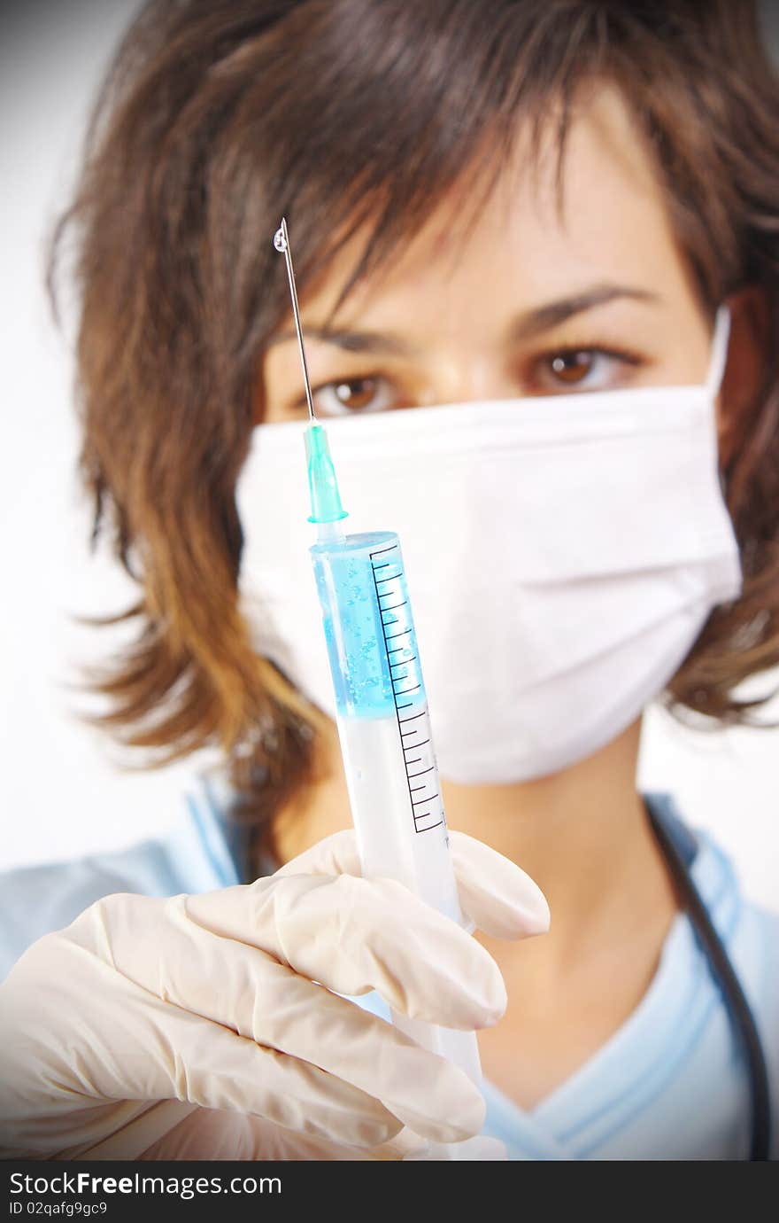 Young medical doctor with syringe