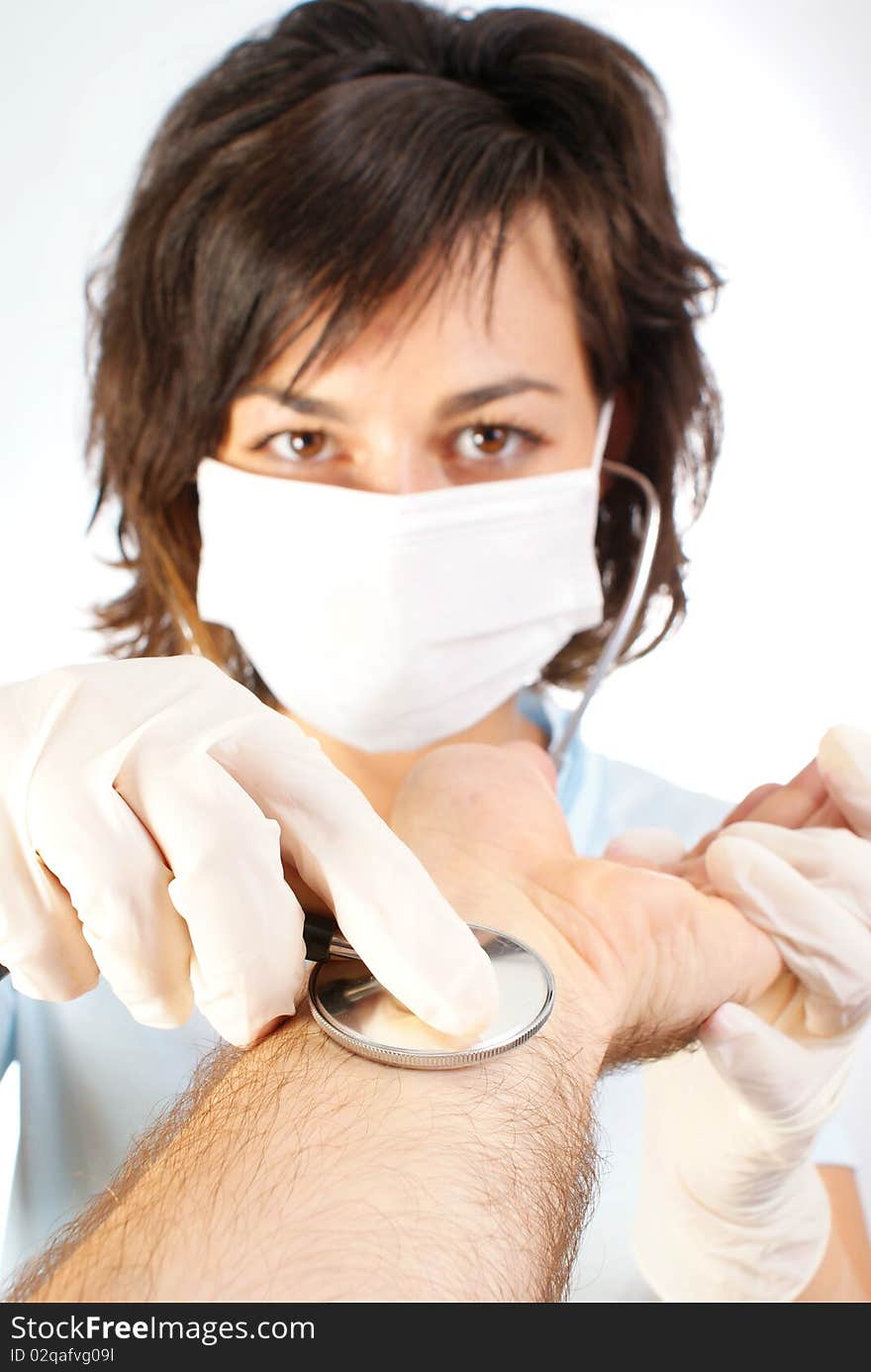 Closeup of nurse using stethoscope on man