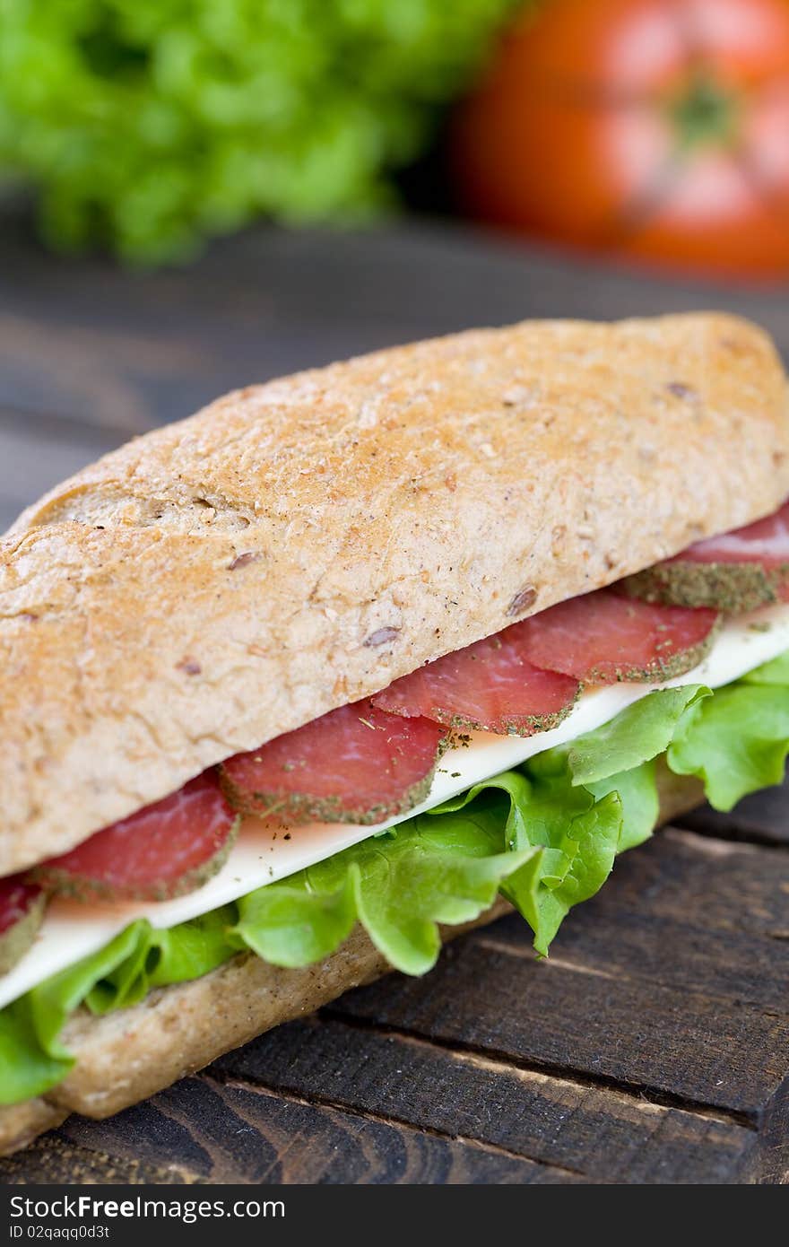 Big freshly made sandwich with lettuce , cheese and meat