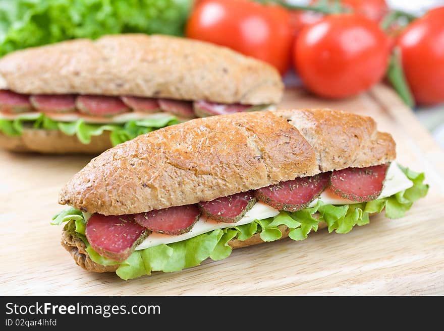 Fresh sandwich with dry meat and cheese on dietetic bread. Fresh sandwich with dry meat and cheese on dietetic bread