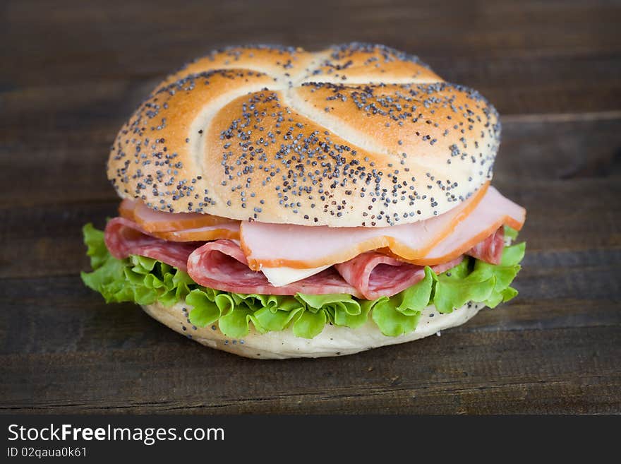 Fresh sandwich on dark wooden table top