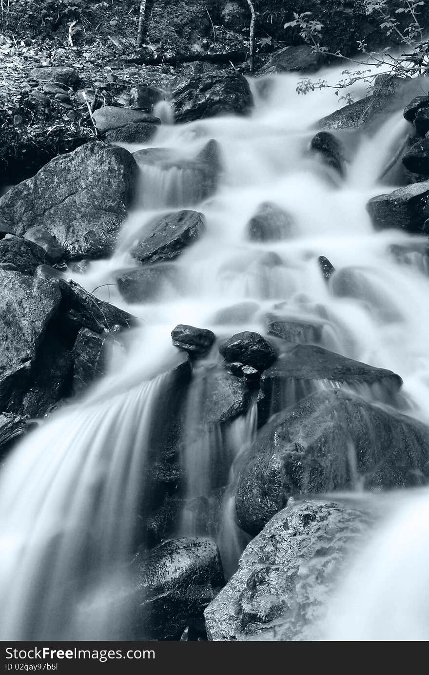 Cold water in winter run on the rocks