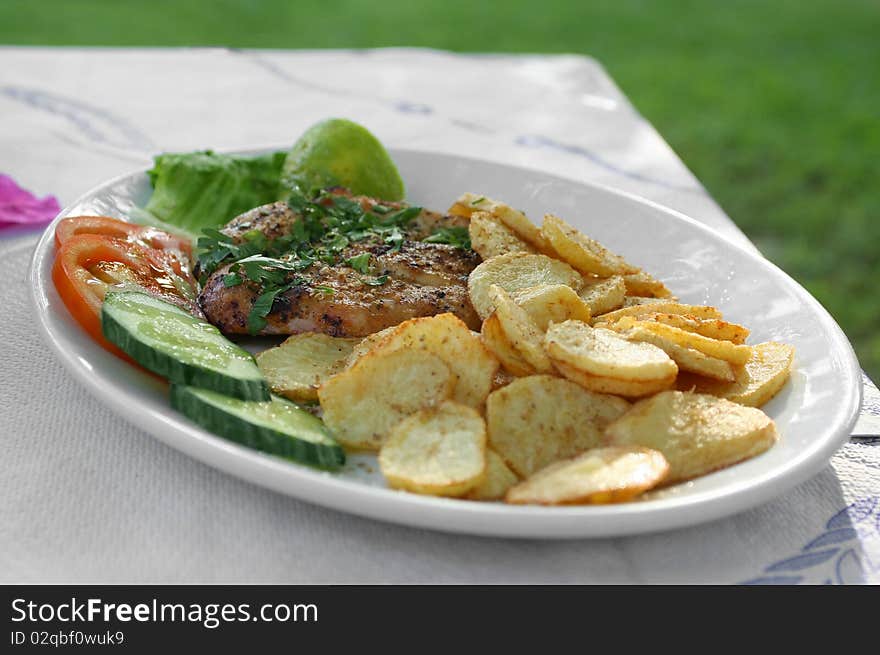 Served meat grill with vegetables in the greek tavern