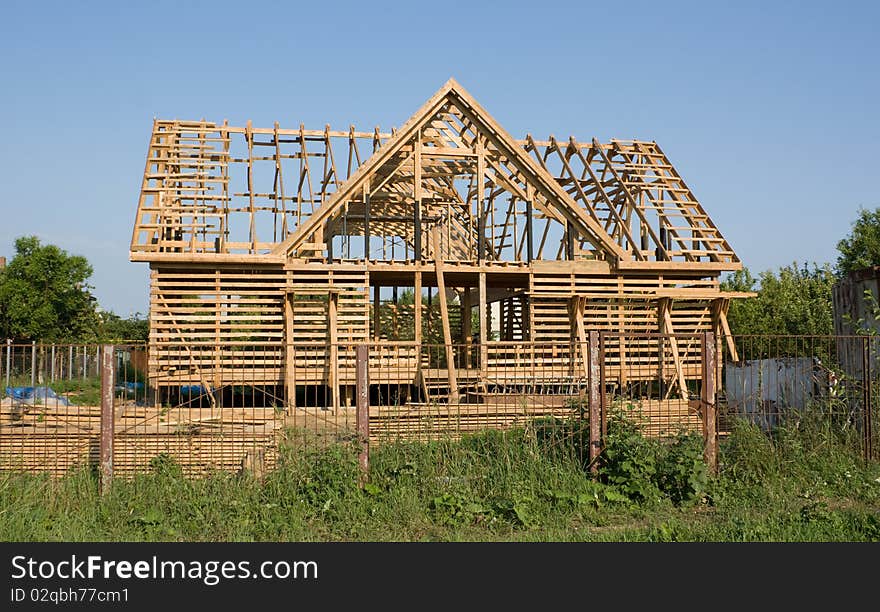 Home construction wooden framing under blue sky. Home construction wooden framing under blue sky