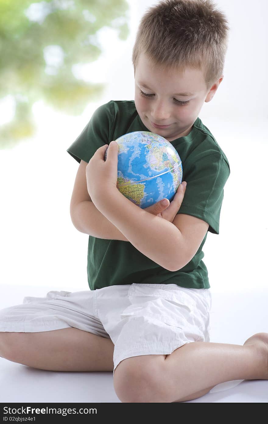 Little boy embracing the globe to protect it. Little boy embracing the globe to protect it