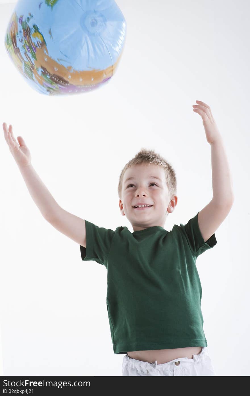 Little boy catching the globe, white background