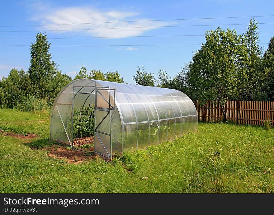 Big hothouse on green field