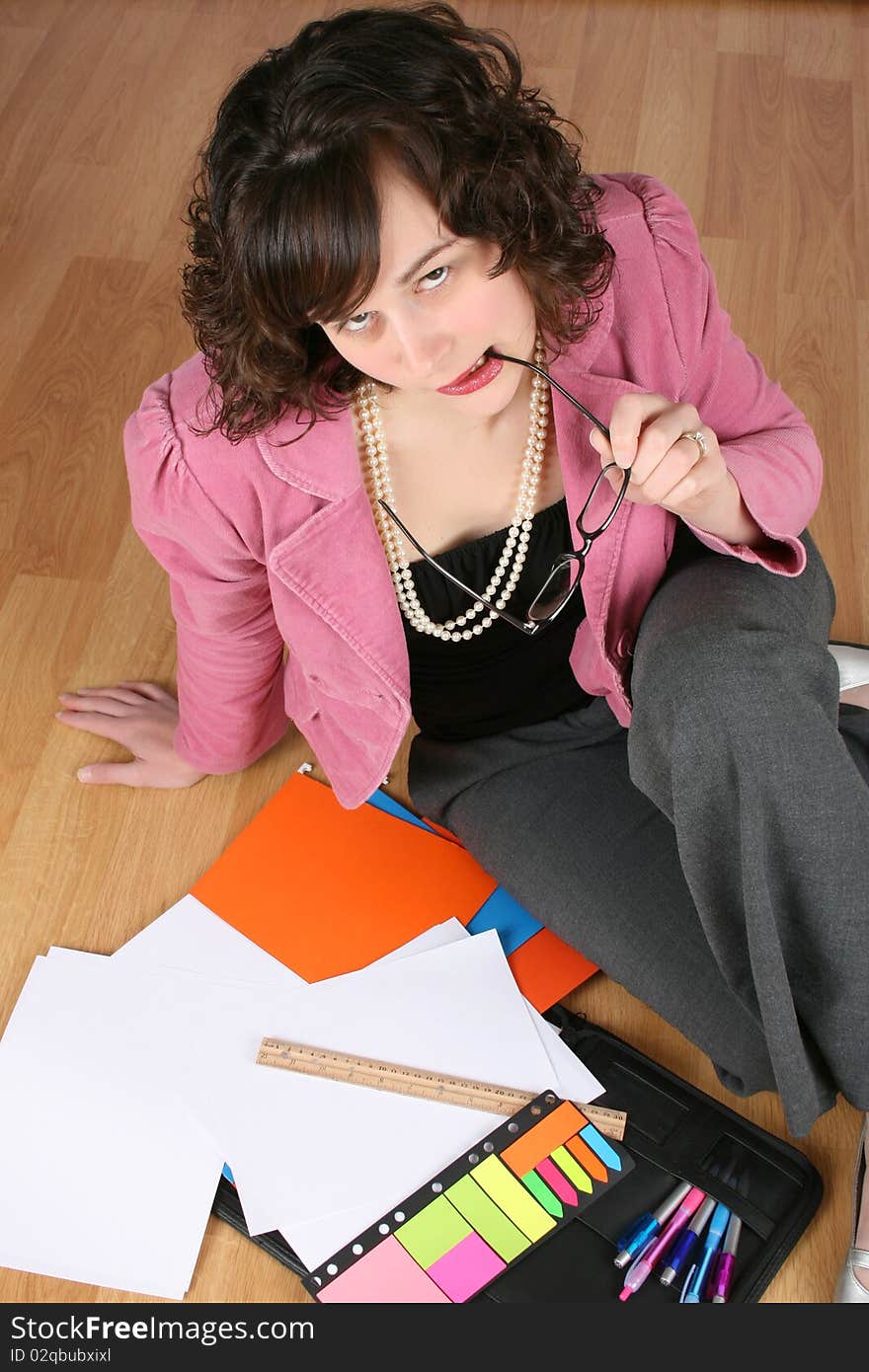 Tired looking business woman sitting on the floor