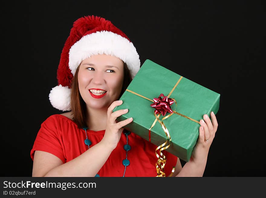 Beautiful caucasian brunette wondering what is inside her gift. Beautiful caucasian brunette wondering what is inside her gift