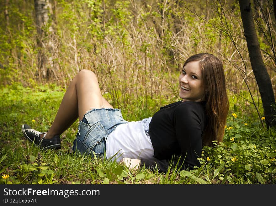 Mystery girl in the autumn leaves smiling