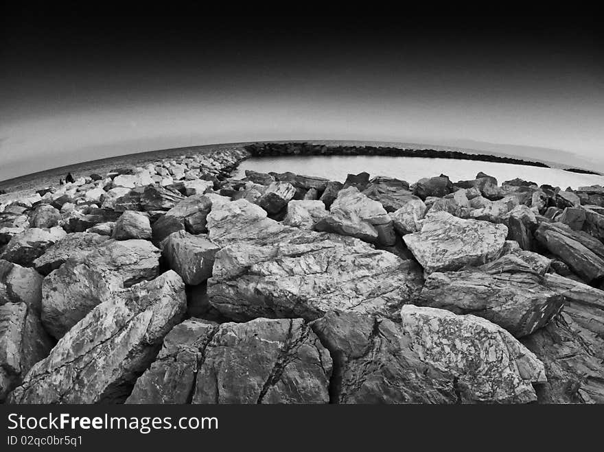 Fisheye View of Rocks over the Sea, Marina di Pisa, Italy. Fisheye View of Rocks over the Sea, Marina di Pisa, Italy