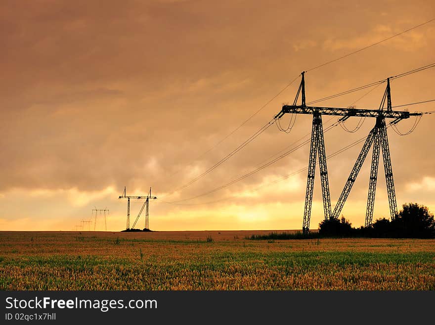 Electric power pylons against sunset sky. Electric power pylons against sunset sky