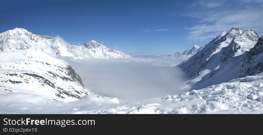 Clouds between the peaks of the Alps. Clouds between the peaks of the Alps