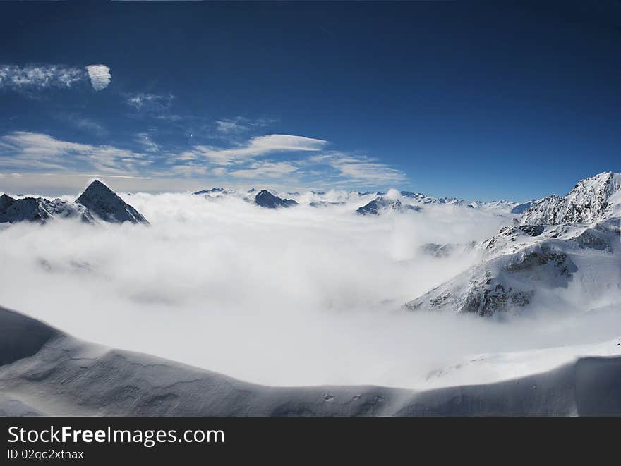 Mountain peaks breaking the clouds. Mountain peaks breaking the clouds