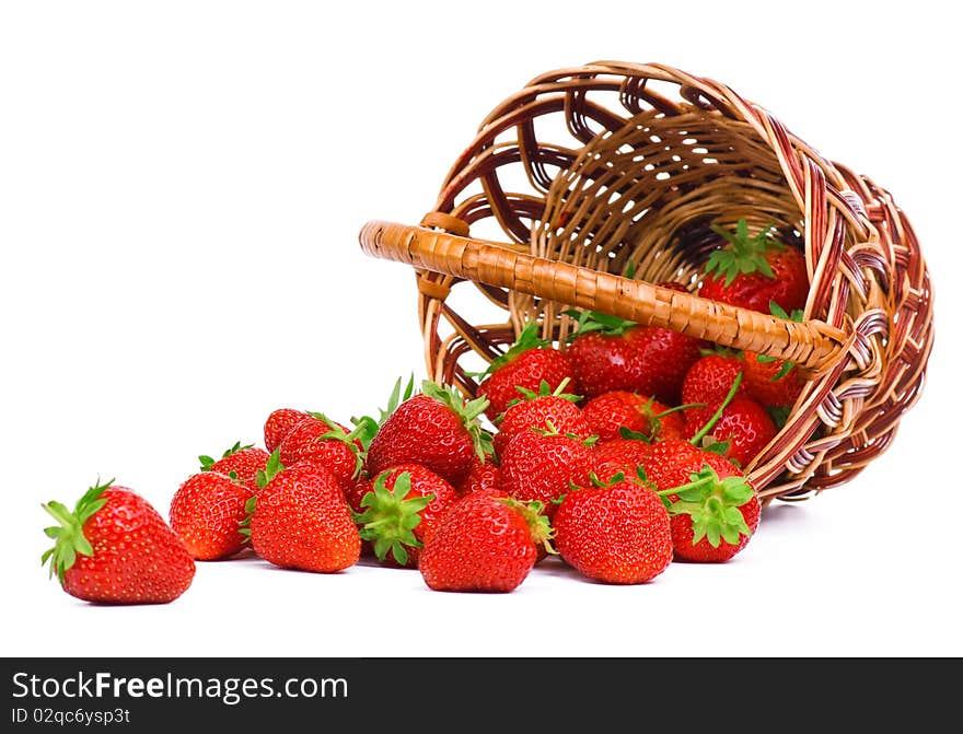 Ripe strawberry in wicker basketbasket isolated on a white background