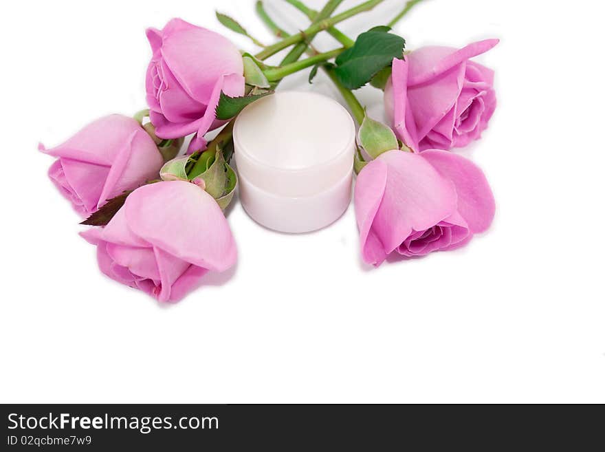 Pink roses and a cosmetic cream isolated on white background. Pink roses and a cosmetic cream isolated on white background