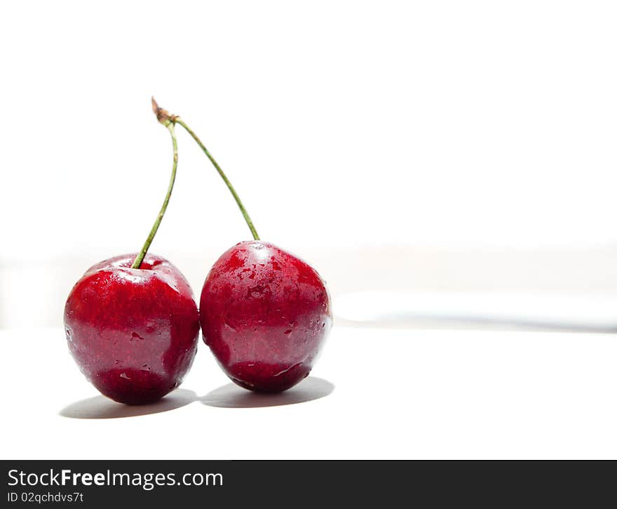 Wet tasty cherries isolated on white