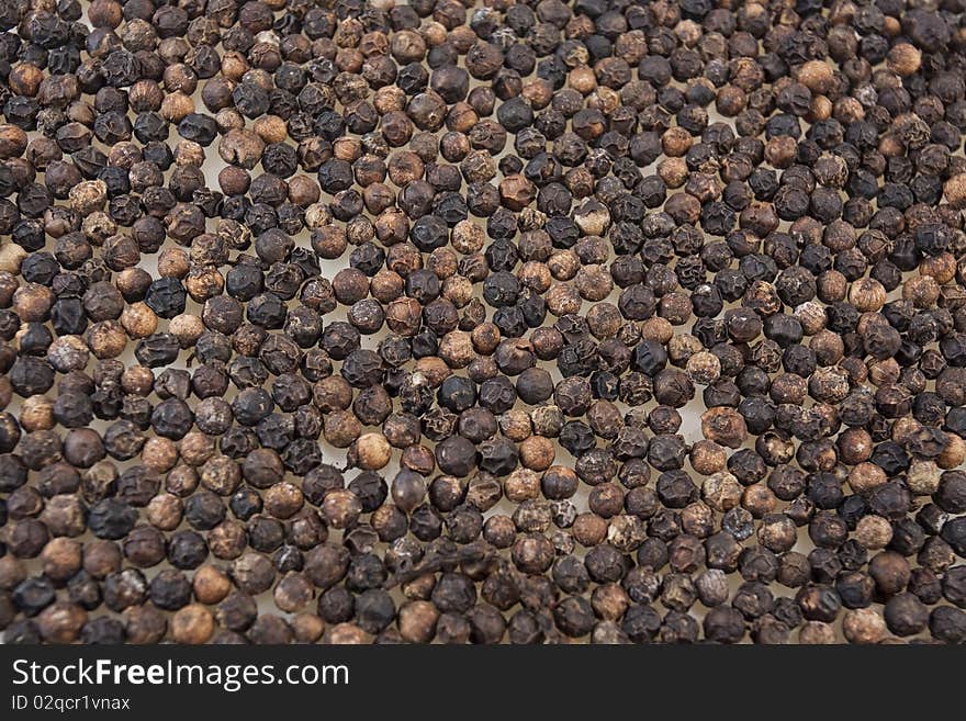 Black peppercorns isolated on white background