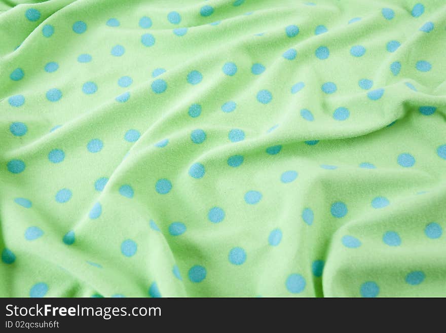 Green fabric with blue polka dots. Green fabric with blue polka dots.