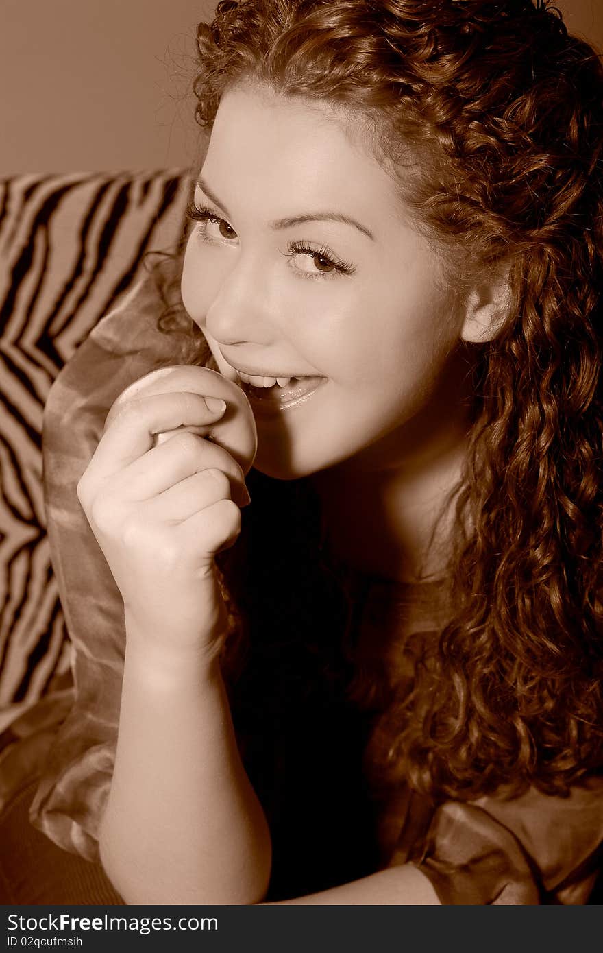 Nice young caucasian girl trying eating an apple with mouth wide open and having fun made in color corrected tonality. Nice young caucasian girl trying eating an apple with mouth wide open and having fun made in color corrected tonality