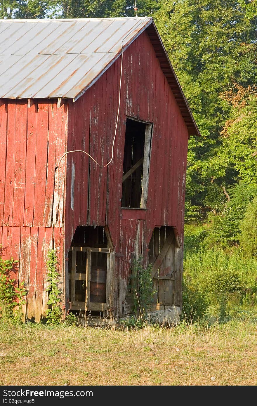 Old red barn in a field.