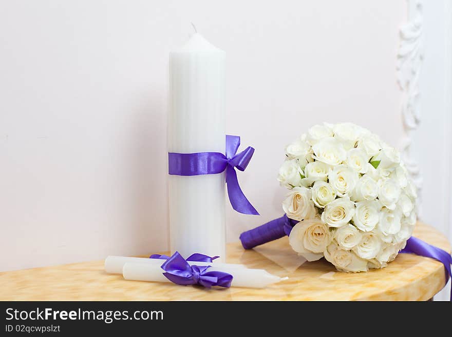 Beautiful wedding bouquet with candles on table