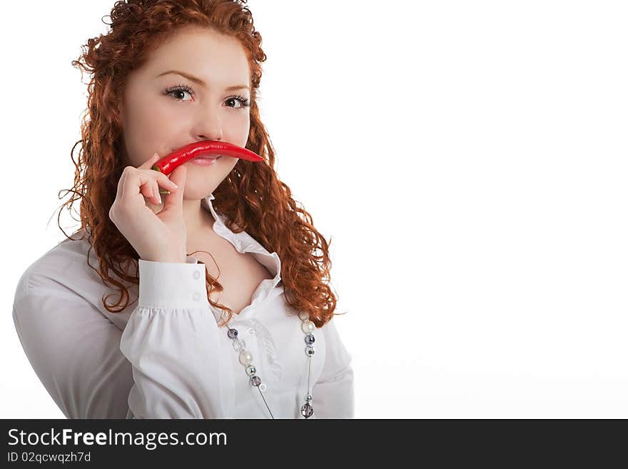 Funny and beautiful young caucasian girl with red hair demonstrating whiskers made of red chilly pepper and standing isolated on white background. Funny and beautiful young caucasian girl with red hair demonstrating whiskers made of red chilly pepper and standing isolated on white background