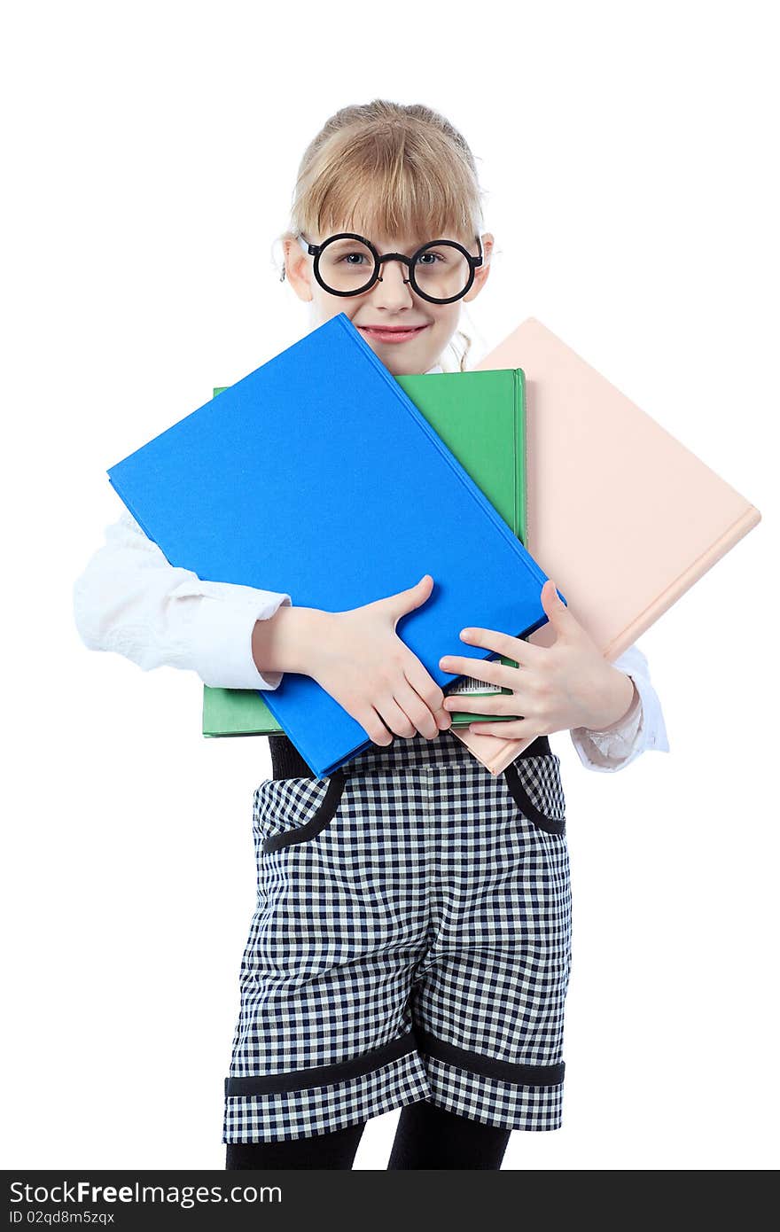 Shot of a little girl in glasses standing with books. Isolated over white background. Shot of a little girl in glasses standing with books. Isolated over white background.