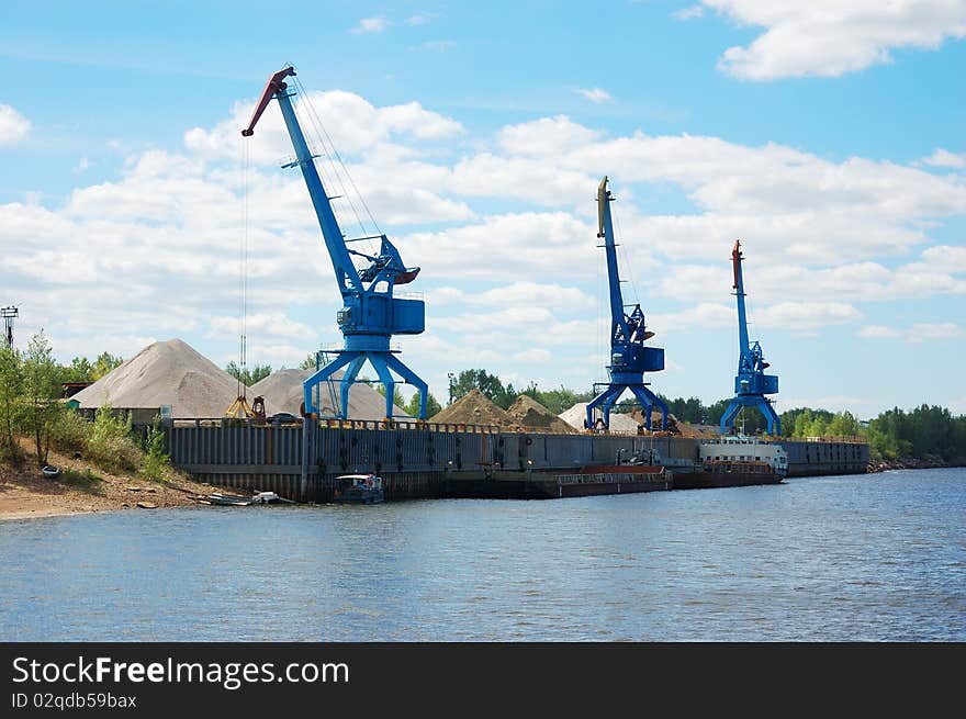 Cranes and sand hills on river port