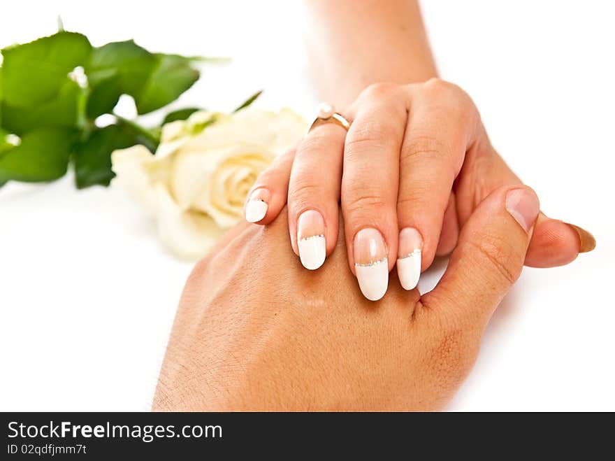 Woman's hand on man's with golden ring on white background. Woman's hand on man's with golden ring on white background