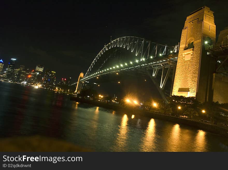 The Harbor Bridge glows at midnight, connecting Sydney's downtown skyline to Milner's point. The Harbor Bridge glows at midnight, connecting Sydney's downtown skyline to Milner's point.