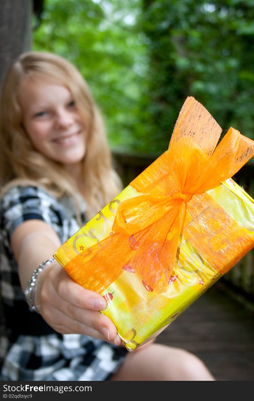 Lady is showing a present to the camera. Lady is showing a present to the camera