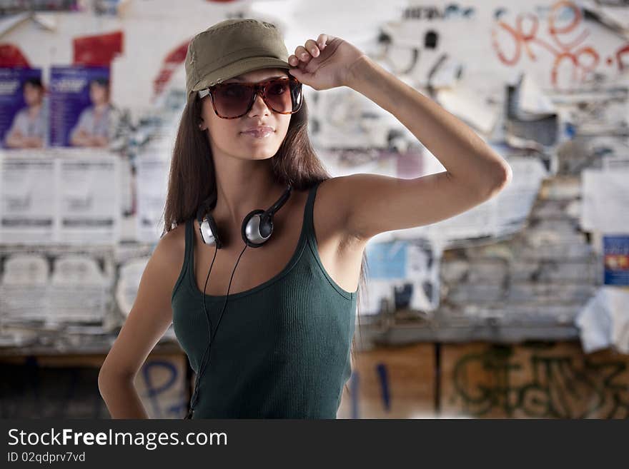 Teenage girl wearing headphones, outdoors