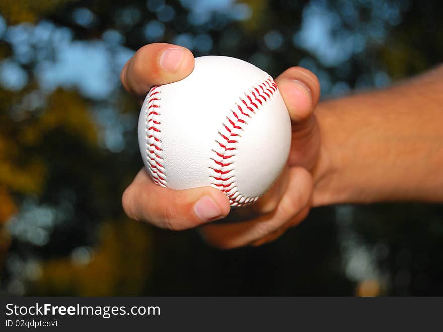 Player Gripping a New Baseball and throws the ball on defense. Player Gripping a New Baseball and throws the ball on defense