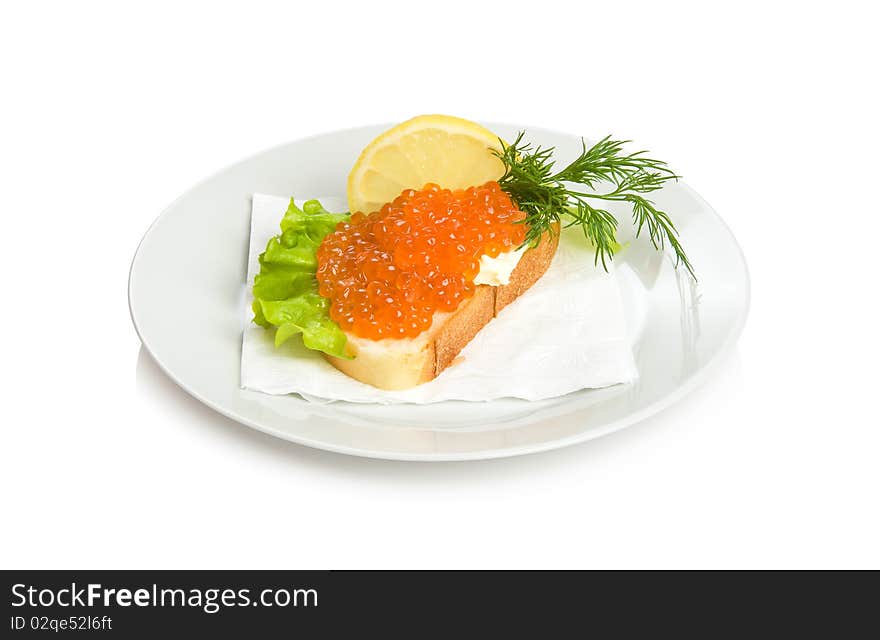 Open sandwich with red caviar, lettuce, lemon and dill.
Isolated on white.