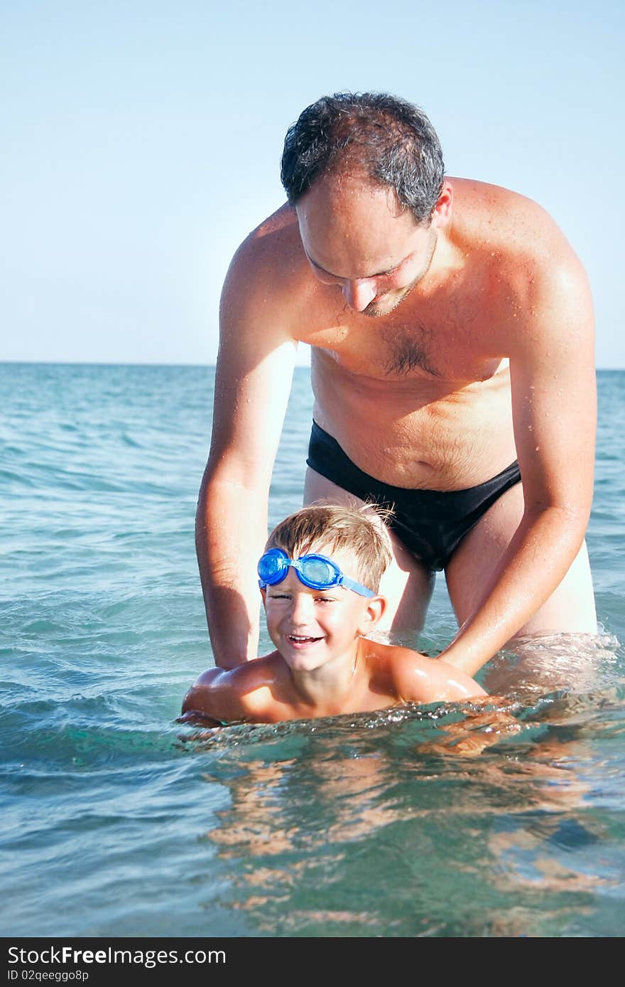 Father teaching son swimming