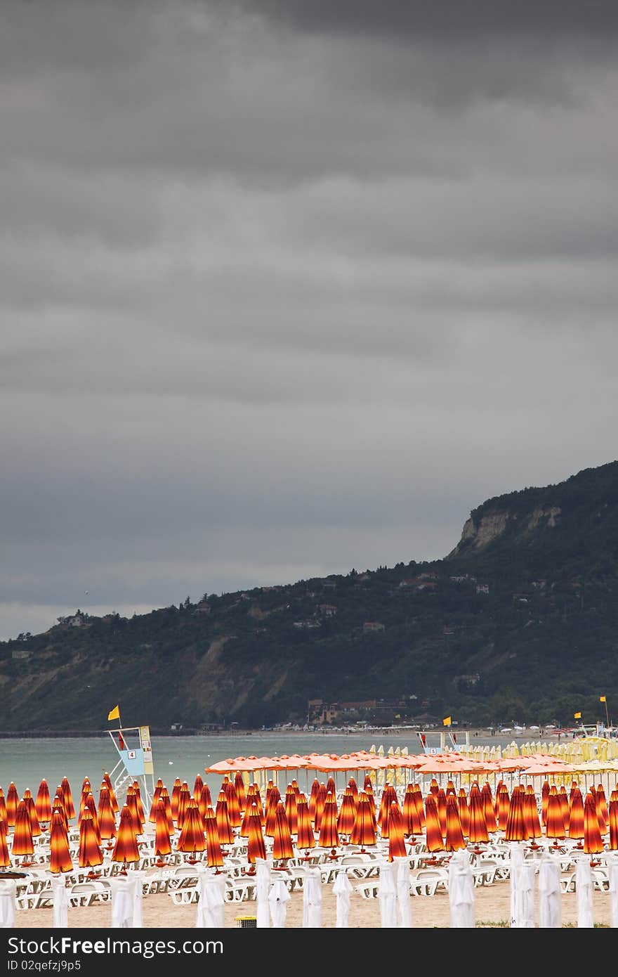 Beach with deckchairs and parasols sea