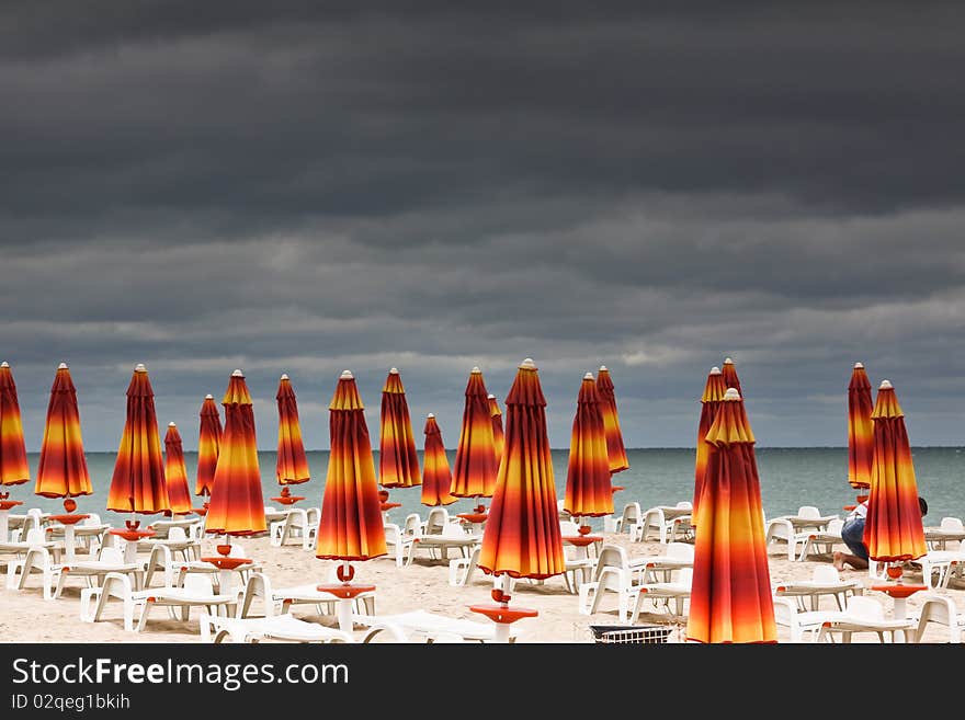 Beach with deckchairs and parasols sea