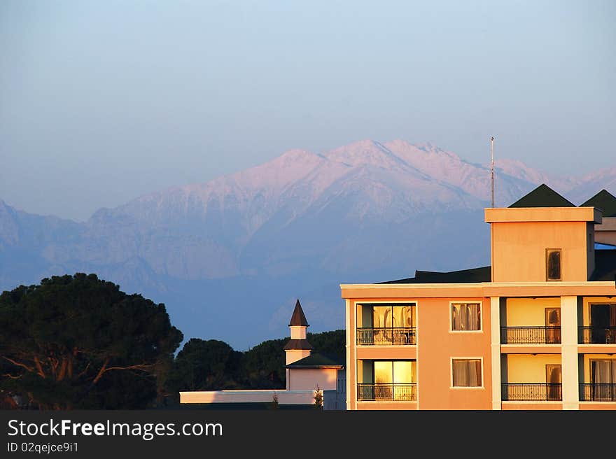 A small hotel on smoky mountains background. Early morning shot. A small hotel on smoky mountains background. Early morning shot.