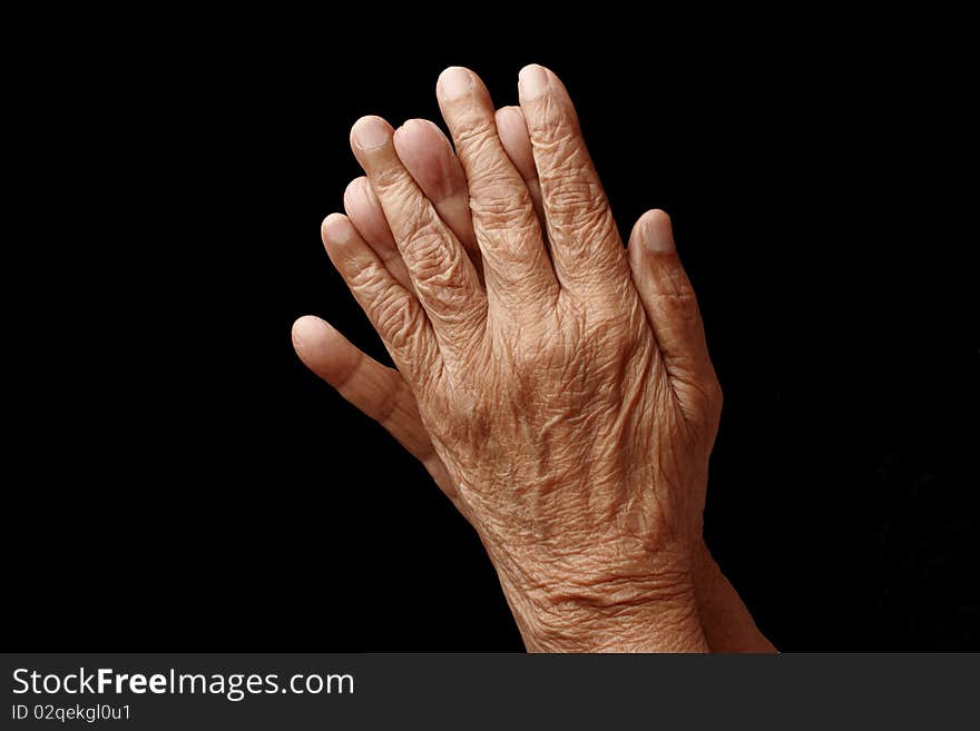 Praying hands of an old woman