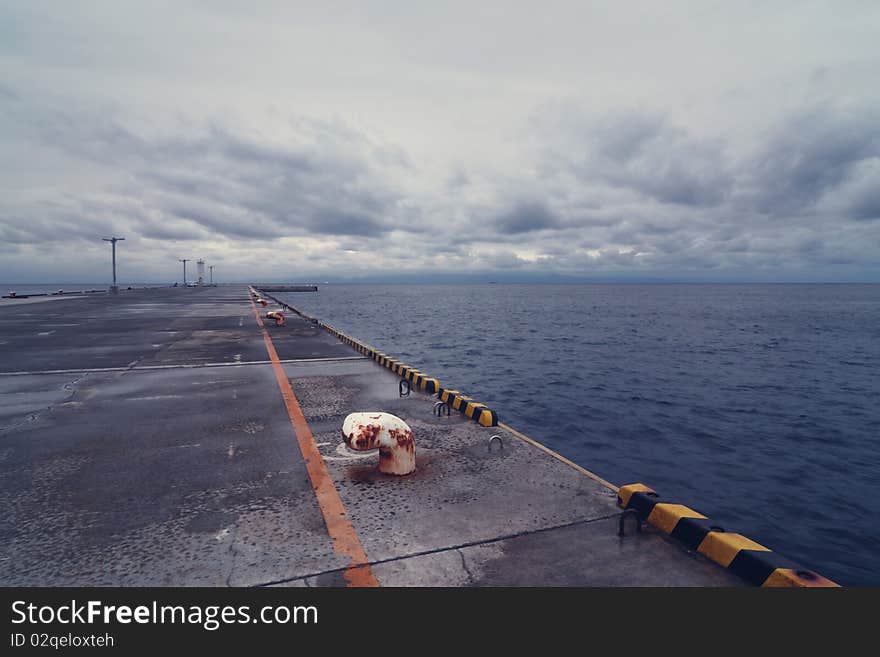 Empty  pier with stormy cloudy sky over Pacific Ocean. Empty  pier with stormy cloudy sky over Pacific Ocean