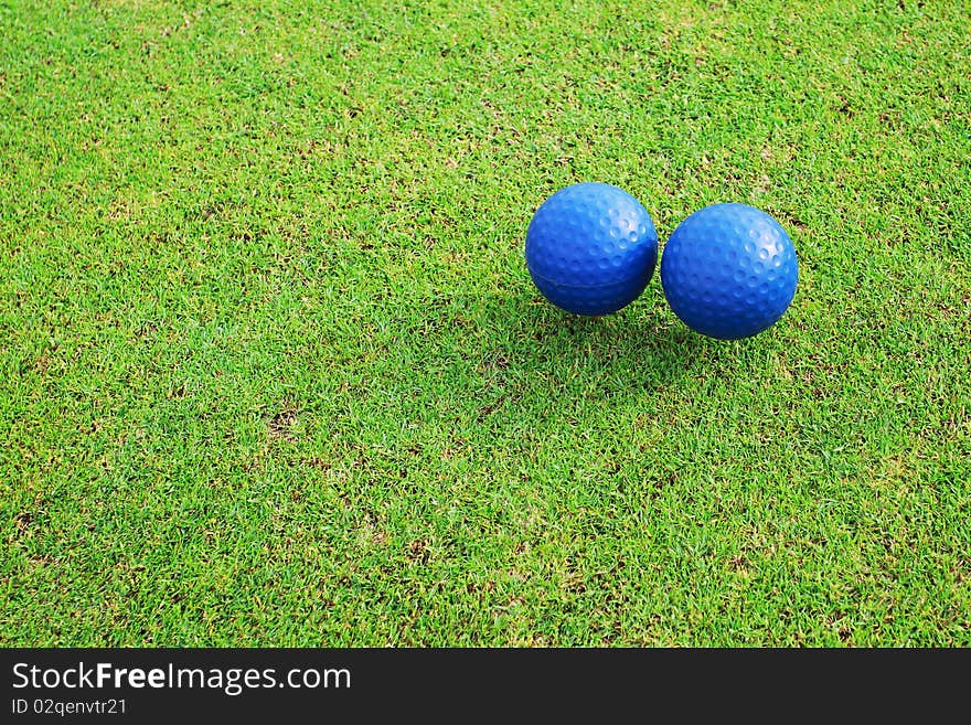 Two ceramic golf ball on green grass