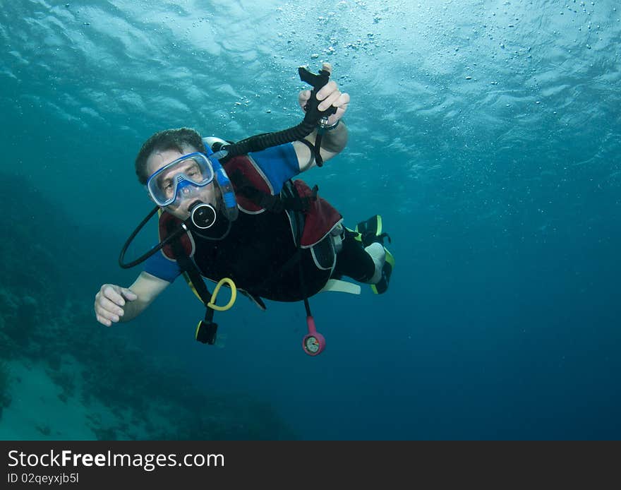 Man scuba diving in clear blue water. Man scuba diving in clear blue water