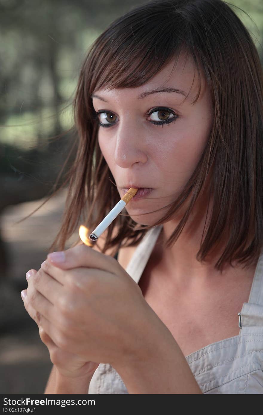 Portrait woman lighting a cigarette