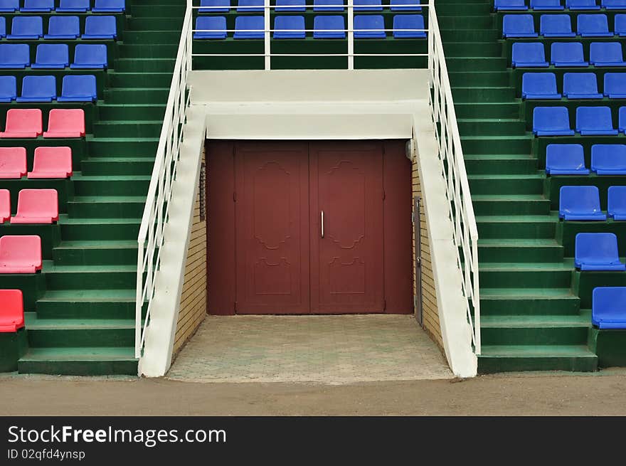 The doors and seats for spectators on the side, colored plastic chairs. The doors and seats for spectators on the side, colored plastic chairs