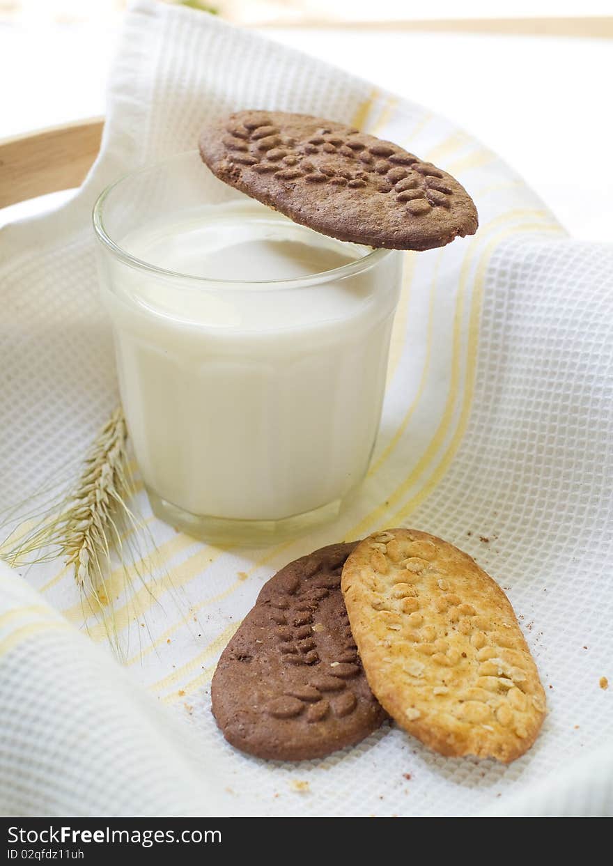 Glass of milk and cookies on light kitchen towel. Glass of milk and cookies on light kitchen towel